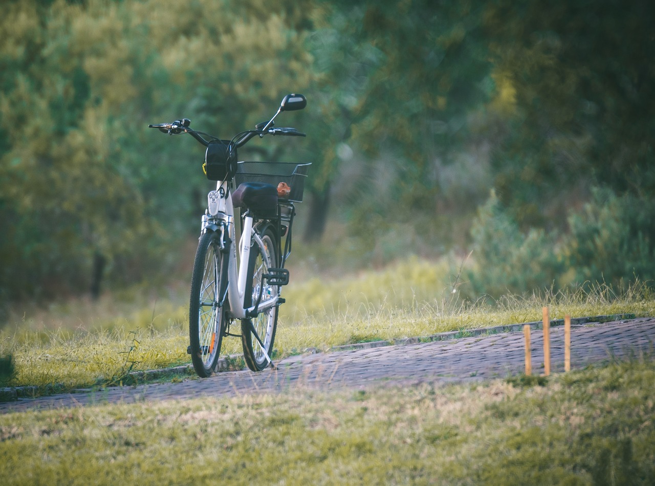 Cyklista na městském elektrokole projíždí rušnou ulicí.
